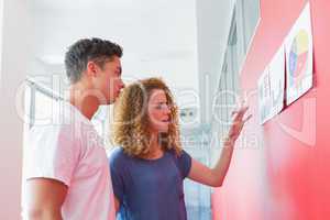 Students studying together with graphics on the wall