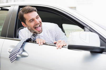 Carefree businessman sitting in drivers seat