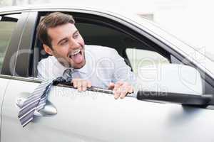 Carefree businessman sitting in drivers seat