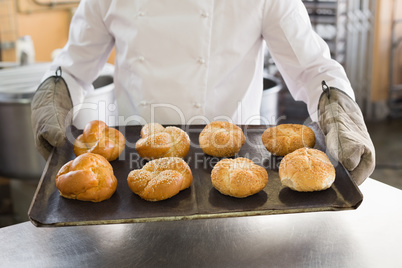Baker showing tray of rolls Baker showing tray of rolls