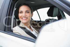 Smiling businesswoman looking out the window