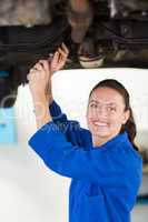 Mechanic examining under the car