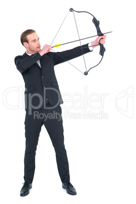 Focused businessman shooting a bow and arrow