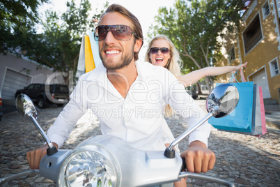 Attractive couple riding a scooter