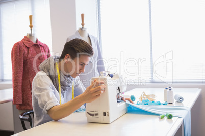 Smiling student using sewing machine