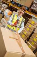 Smiling warehouse workers preparing a shipment