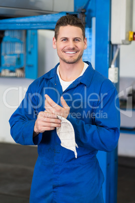 Mechanic wiping hands with rag