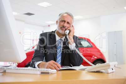 Upset businessman making a phone call