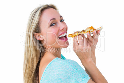 Smiling blonde eating slice of pizza Smiling blonde eating slice of pizza