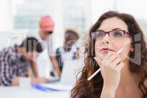 Portrait of businesswoman with glasses thinking
