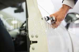 Man holding a car door handles