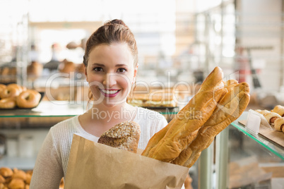 Pretty brunette with bag of bread