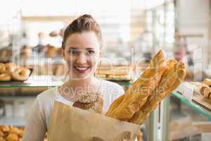 Pretty brunette with bag of bread