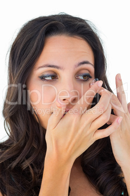 Pretty brunette putting in contact lens