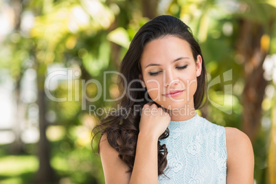 Stylish brunette smiling in the park