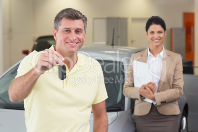 Smiling customer showing his new car key