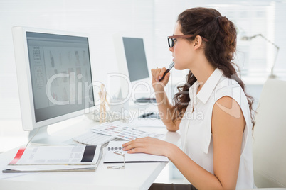 Concentrated businesswoman using computer monitor