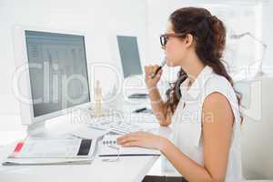 Concentrated businesswoman using computer monitor