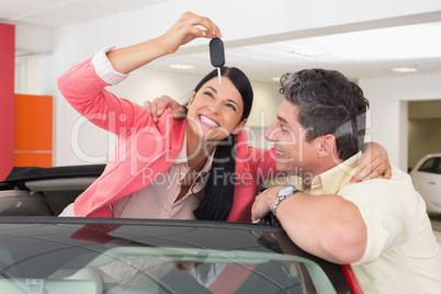 Smiling couple buying a new car