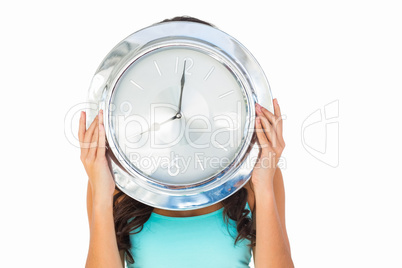 Pretty brunette holding a clock Pretty brunette holding a clock