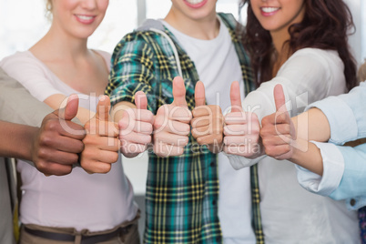 Fashion students showing thumbs up