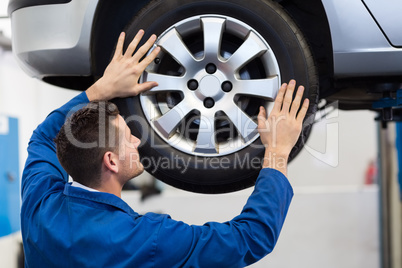 Mechanic adjusting the tire wheel