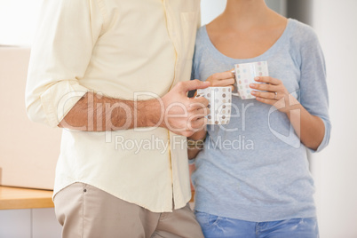 Mid section of young couple smiling at the camera