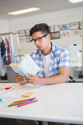 Concentrated college student reading book