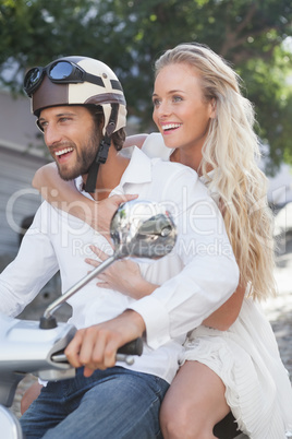 Cute couple riding a scooter