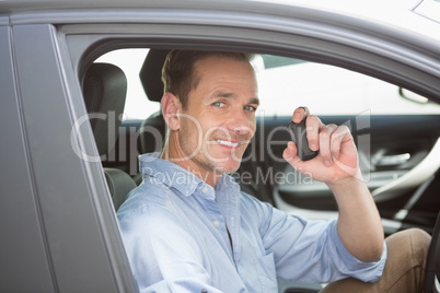 Handsome man smiling and holding key