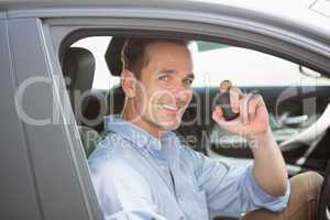 Handsome man smiling and holding key