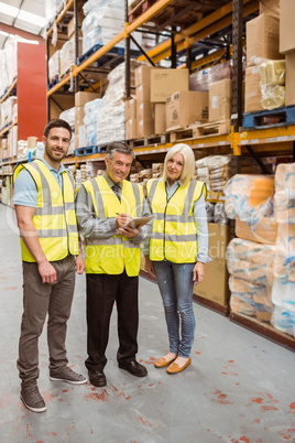 Warehouse team working together wile smiling at camera