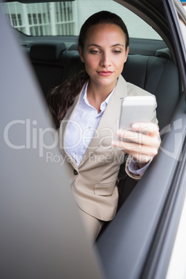 Focused businesswoman using her phone
