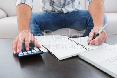 A businessman working on his finances at a table