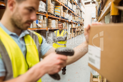 Warehouse worker scanning barcode on box