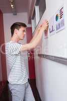 Student putting graphics on the wall