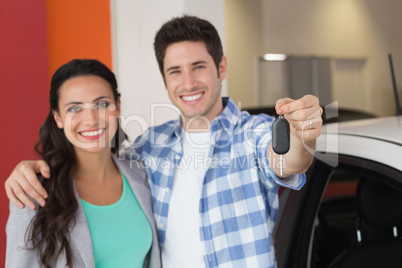 Smiling couple holding their new car key