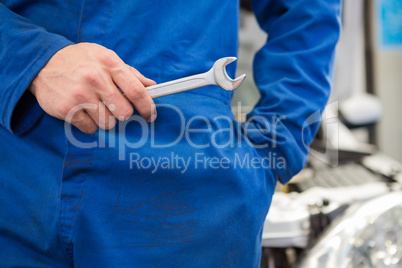 Mechanic standing with wrench in hand