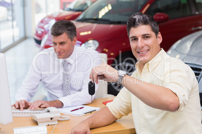 Smiling customer showing his new key