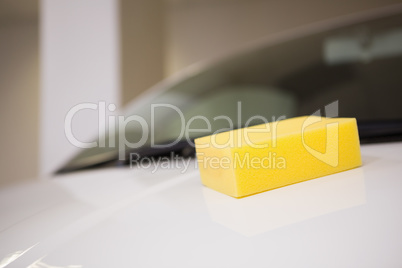 Close up of a yellow sponge on a car