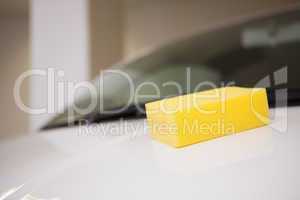 Close up of a yellow sponge on a car