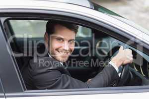 Happy businessman in the drivers seat