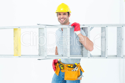 Confident worker carrying step ladder