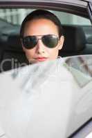 Woman wearing sunglasses looking at camera