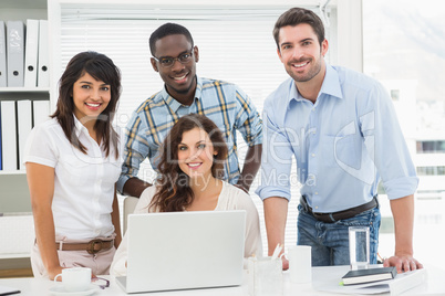 Smiling coworkers looking at camera