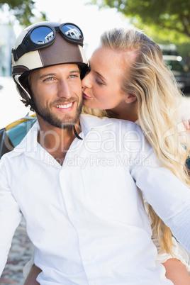 Attractive couple riding a scooter