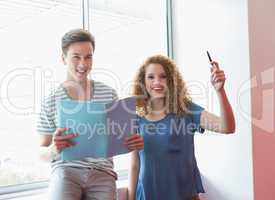 Smiling student holding notebook and pen