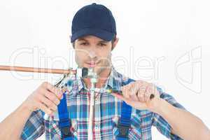 Plumber fixing pipe over white background
