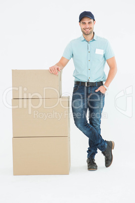 Confident delivery man with cardboard boxes