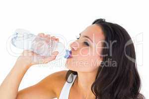 Pretty brunette drinking bottle of water